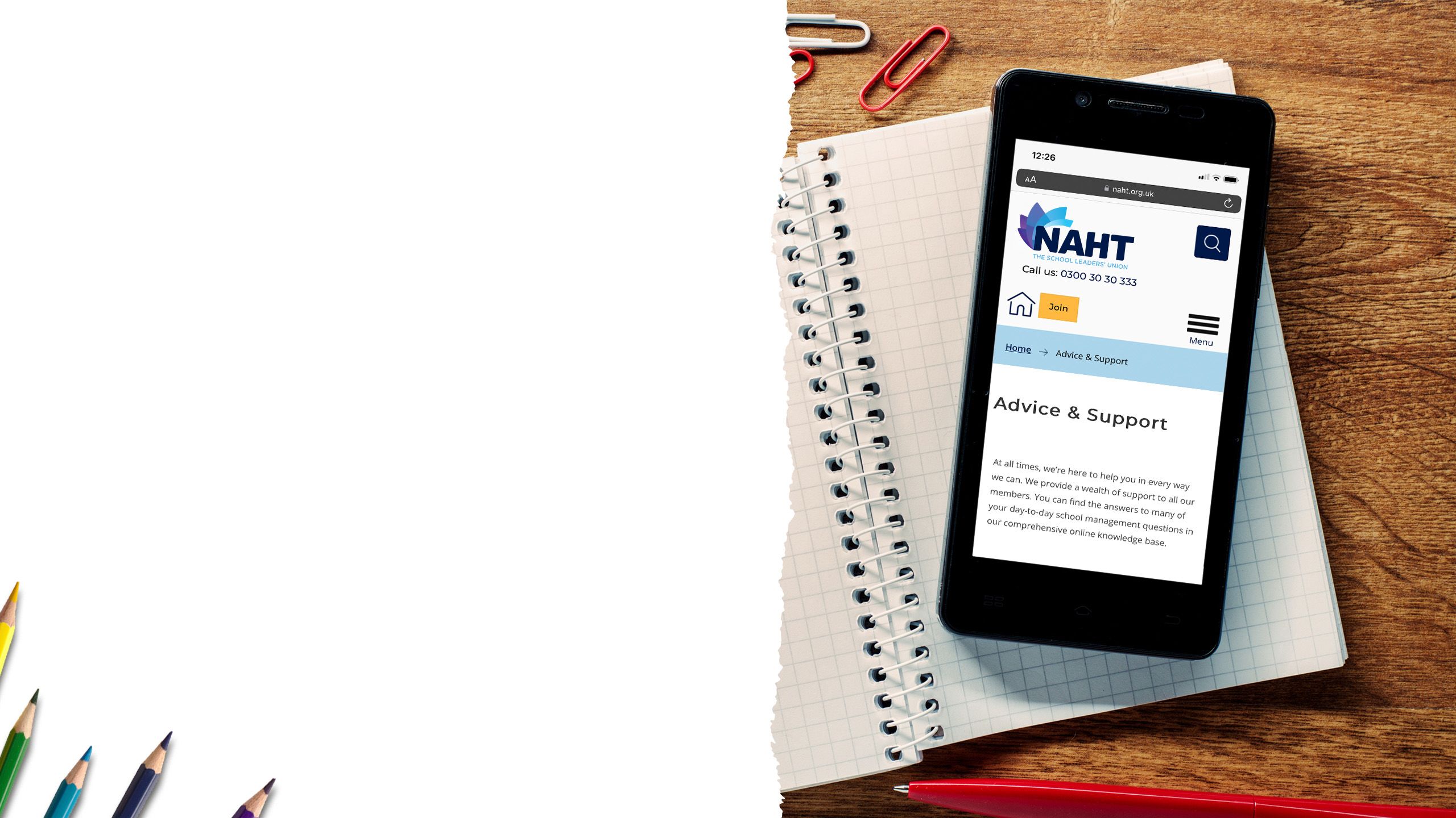 Smartphone on a table displaying advice and support information on the screen.