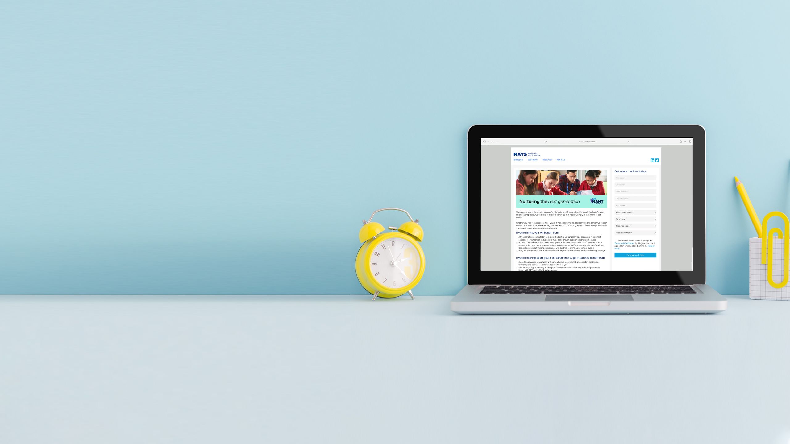 Laptop on a desk displaying homepage screens of relevant partner websites.