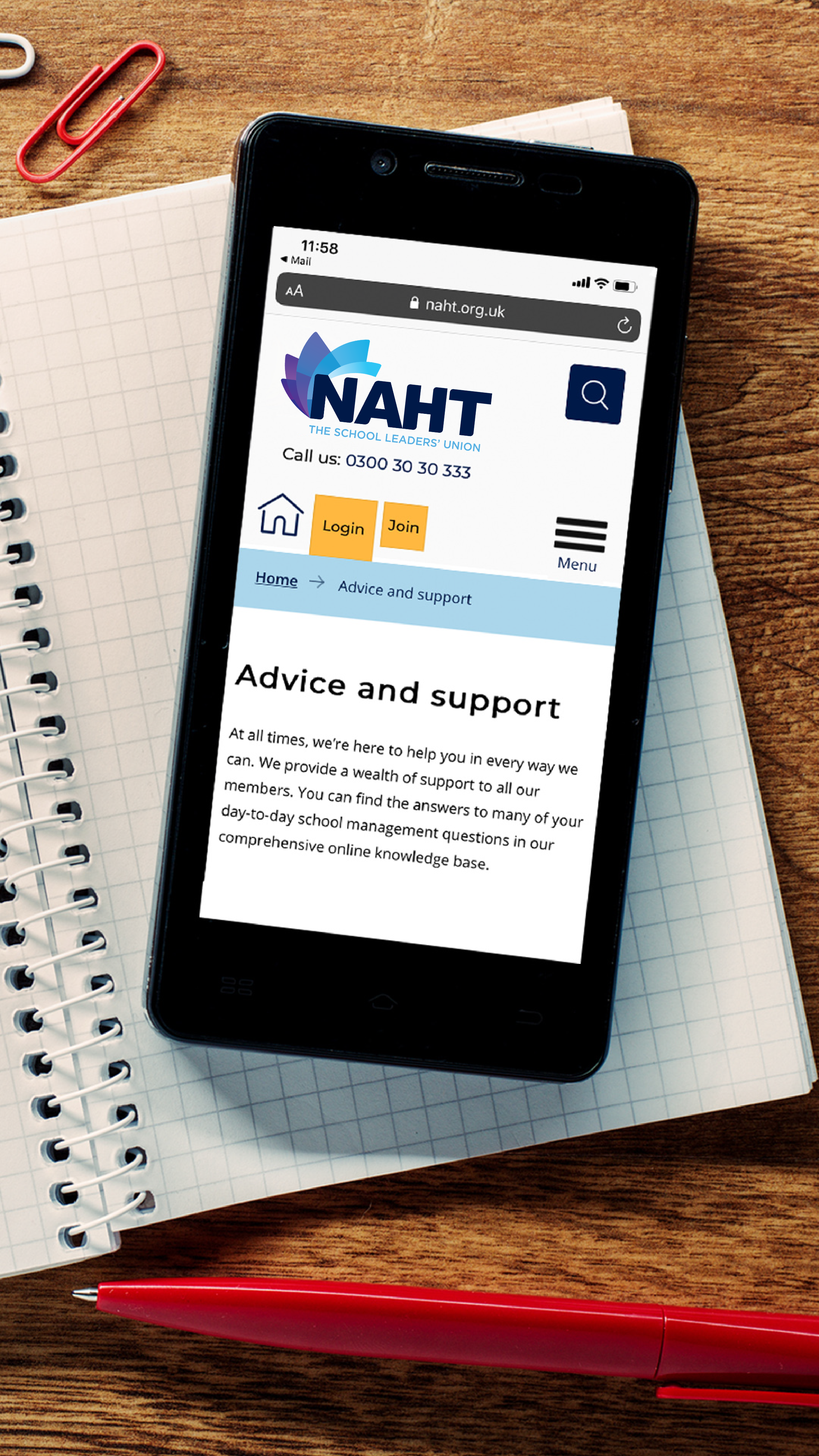 Smartphone on a table displaying advice and support information on the screen.