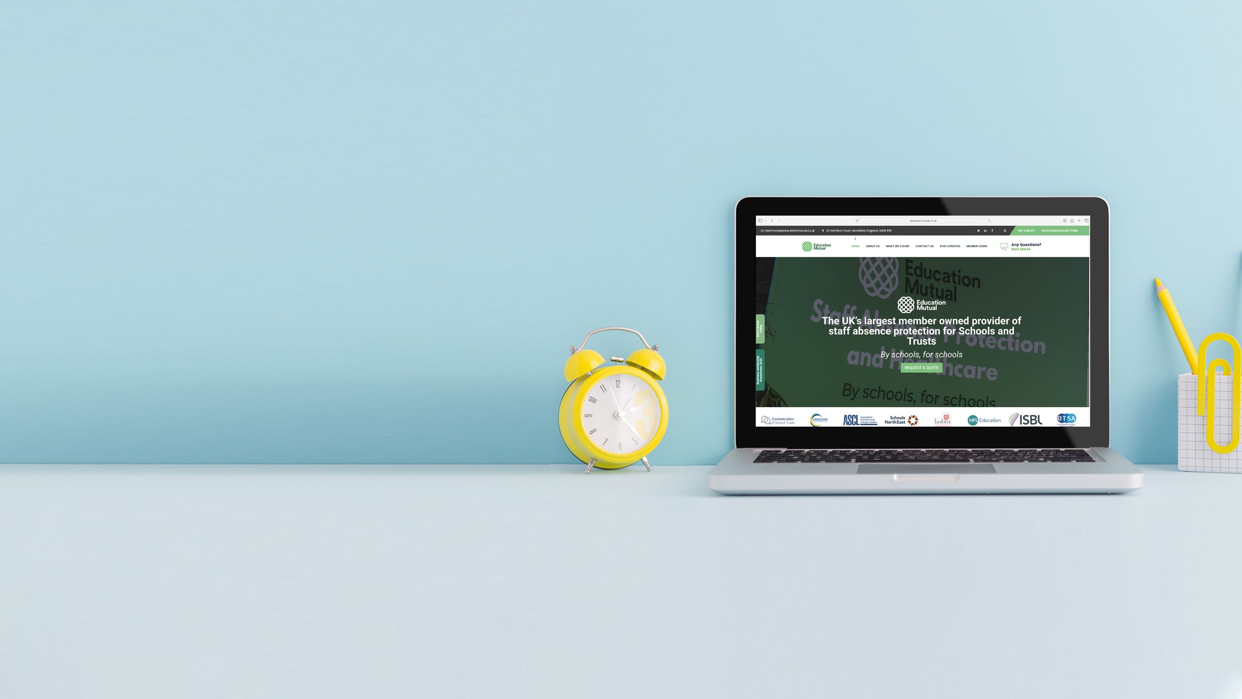 Laptop on a desk displaying homepage screens of relevant partner websites.