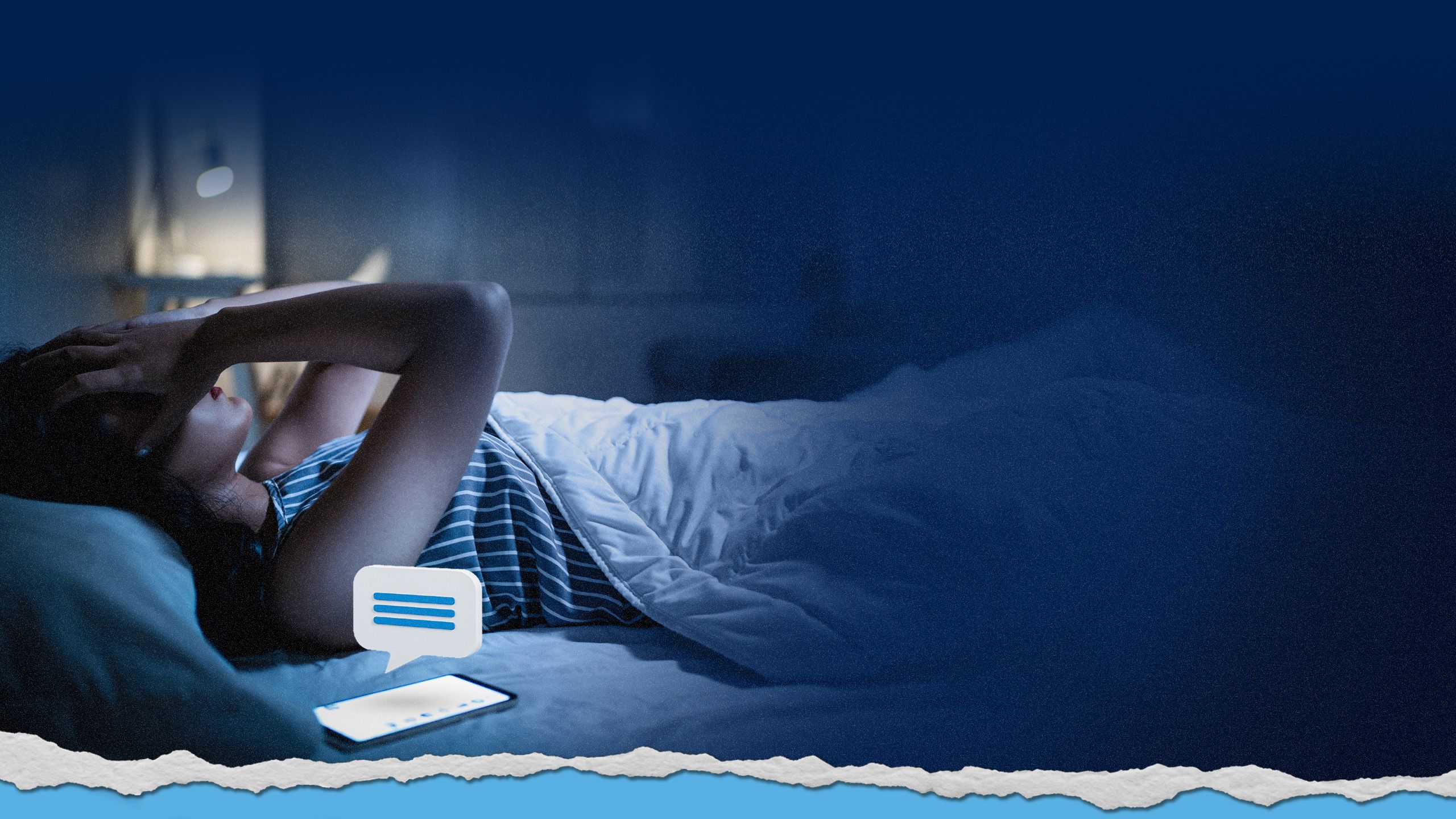 Person in bed looking stressed after reading phone messages.